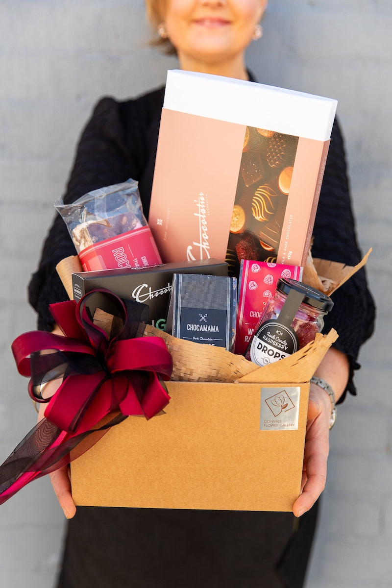 Image of a Donvale Flower Gallery team member holding the Chocolate Lovers Hamper.