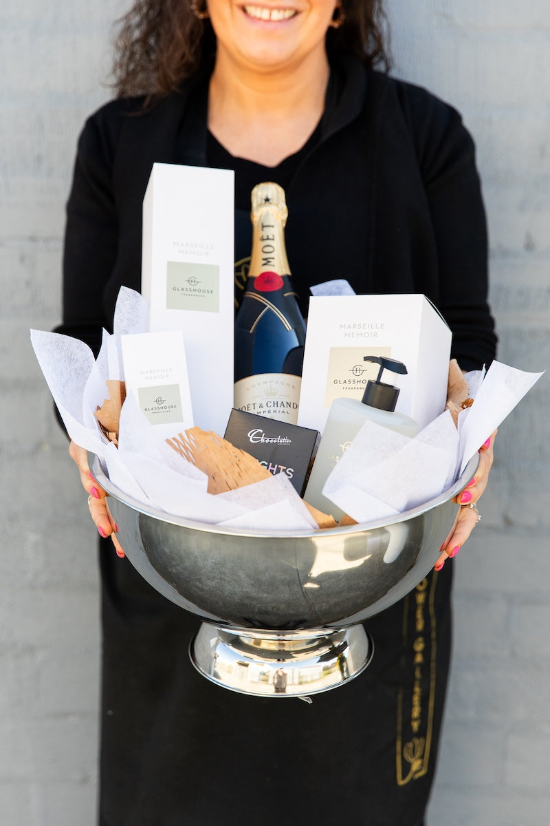 Image of a Donvale Flower Gallery team member holding the French Memoir gift hamper.