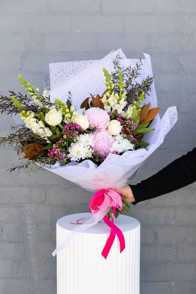 Image of the Astrid flower bouquet consisting of white and pink flowers along with various greenery.