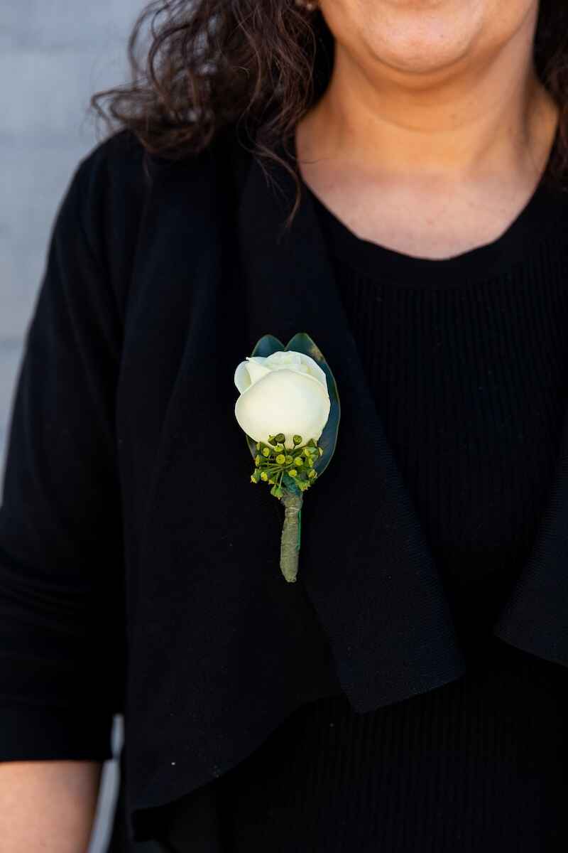 Image of the Rose Buttonhole pinned on to a person's top. Perfect for school formals. Available to buy from Donvale Flower Gallery in-store or online (Melbourne area only).