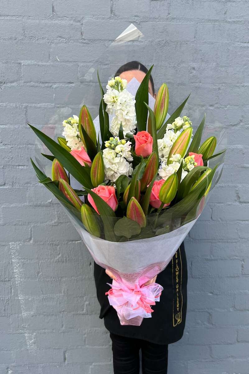 Image of a Donvale Flower Gallery team member holding the Eva bouquet of fresh flowers.