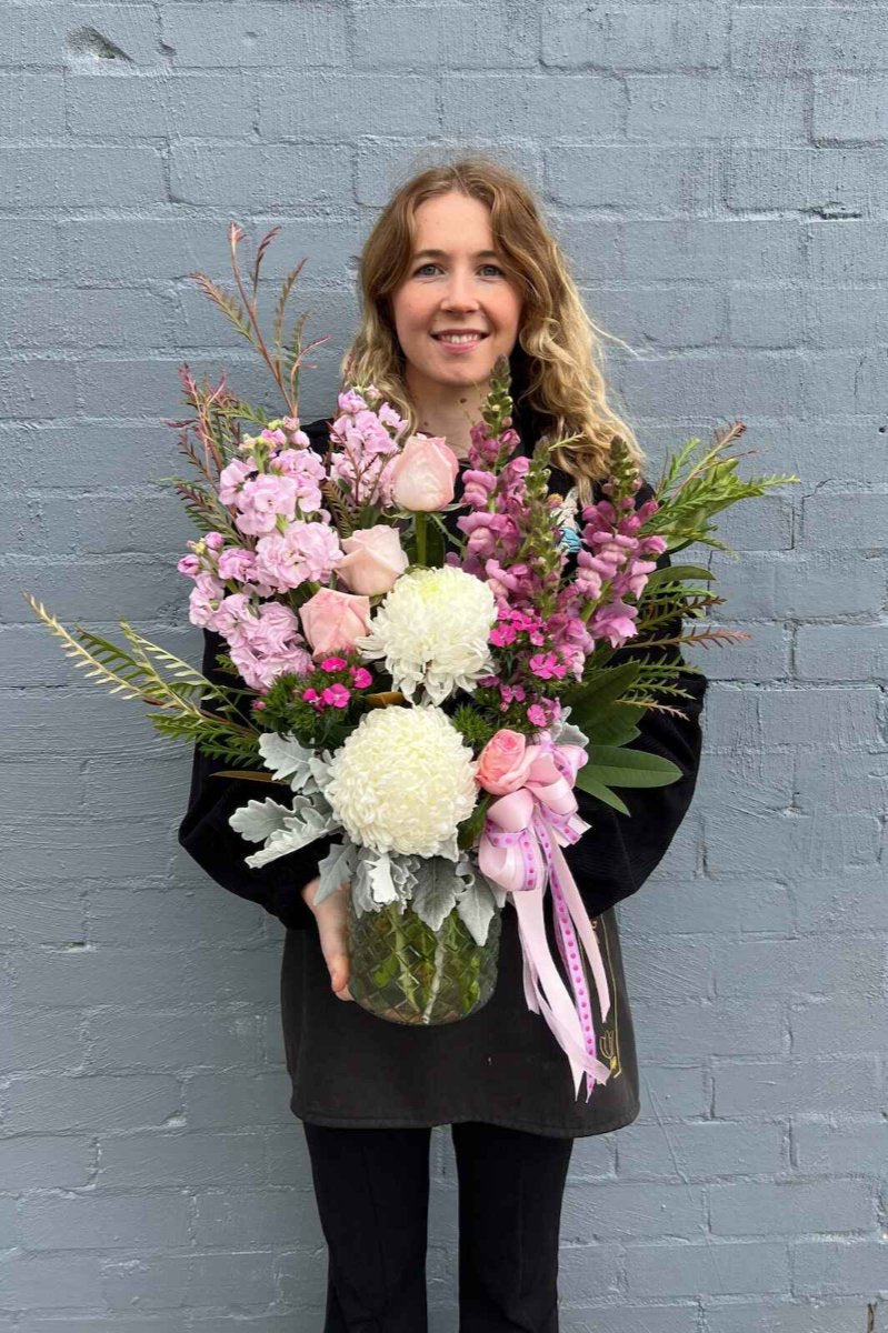 Image of a Donvale Flower Gallery team member holding the "Helen" flower bouquet.